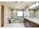 Beautiful bathroom with a marble countertop, dual sinks, and a large glass-enclosed shower at 5301 Fairbranch Ln, Las Vegas, NV 89135