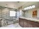 Spa-like bathroom boasting dual sinks, marble countertops, custom cabinets, and a glass-enclosed shower at 5301 Fairbranch Ln, Las Vegas, NV 89135