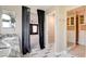 Bathroom featuring marble countertops, custom cabinets, and access to a custom walk-in closet at 5301 Fairbranch Ln, Las Vegas, NV 89135