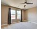 Bright bedroom with neutral carpet, ceiling fan, and natural light from two windows at 5301 Fairbranch Ln, Las Vegas, NV 89135