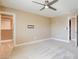 Bright bedroom with carpet, ceiling fan, and a closet with shelving at 5301 Fairbranch Ln, Las Vegas, NV 89135