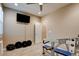 The exercise room features a wall-mounted TV, workout equipment, and hardwood-style floors at 5301 Fairbranch Ln, Las Vegas, NV 89135
