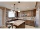Spacious kitchen with granite counters, island seating and modern stainless steel appliances at 5301 Fairbranch Ln, Las Vegas, NV 89135