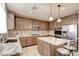 Modern kitchen with stainless appliances, granite counters, and center island with seating at 5301 Fairbranch Ln, Las Vegas, NV 89135