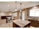 Open floor plan featuring a kitchen with island, counter seating, and view to living area at 5301 Fairbranch Ln, Las Vegas, NV 89135