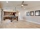 Open concept living room and kitchen with light wood floors and ceiling fan at 5301 Fairbranch Ln, Las Vegas, NV 89135