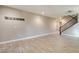 Open-concept living room featuring tile floors, and a staircase, perfect for entertaining at 5301 Fairbranch Ln, Las Vegas, NV 89135