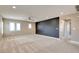 The neutral-toned loft features plush carpeting, ample windows and a stylish black accent wall at 5301 Fairbranch Ln, Las Vegas, NV 89135
