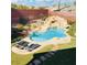 Inviting backyard pool with rock waterfall feature and lounge chairs for relaxation and enjoyment at 5301 Fairbranch Ln, Las Vegas, NV 89135