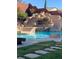 Backyard pool with a stunning rock waterfall feature and slide, perfect for outdoor fun and relaxation at 5301 Fairbranch Ln, Las Vegas, NV 89135