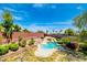 Backyard view of a private in-ground pool with a waterfall feature and mature landscaping at 5301 Fairbranch Ln, Las Vegas, NV 89135
