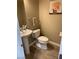 This powder room features a pedestal sink, toilet and a small accent painting at 5301 Fairbranch Ln, Las Vegas, NV 89135