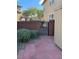 Side yard access through a metal gate in a red brick wall with adjacent storage shed and brick paver walkway at 5301 Fairbranch Ln, Las Vegas, NV 89135
