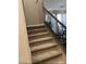 Carpeted staircase featuring a decorative metal banister at 5301 Fairbranch Ln, Las Vegas, NV 89135