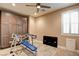 Workout room with exercise equipment, built-in cabinet storage, and window with shutters at 5301 Fairbranch Ln, Las Vegas, NV 89135
