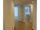 Bright hallway with hardwood floors and neutral paint at 1335 Temporale Dr, Henderson, NV 89052