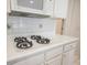 Kitchen detail showing gas cooktop and white cabinets at 1335 Temporale Dr, Henderson, NV 89052