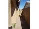 Side yard featuring paver walkway that leads to wrought-iron gate at 3505 Benson Ln, North Las Vegas, NV 89032