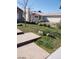 View of the backyard showing grass and rock landscaping on a sunny day at 3505 Benson Ln, North Las Vegas, NV 89032