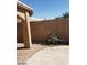 View of a backyard with concrete and paver patios, block wall and covered area at 3505 Benson Ln, North Las Vegas, NV 89032