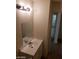 Bathroom featuring a single sink vanity with a mirror and three-light fixture at 3505 Benson Ln, North Las Vegas, NV 89032