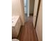 Neutral bathroom featuring wood-look floors, vanity with solid surface counter, and door to hall at 3505 Benson Ln, North Las Vegas, NV 89032