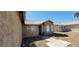Beige single story home with well manicured rock landscaping, concrete walkway, and tile roof at 3505 Benson Ln, North Las Vegas, NV 89032