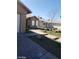 Exterior view of the property highlighting walkway, rock landscaping, and neutral exterior at 3505 Benson Ln, North Las Vegas, NV 89032