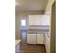 An open kitchen with white cabinets and matching appliances at 3505 Benson Ln, North Las Vegas, NV 89032