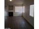 Living room featuring wood flooring, modern fixtures, a fireplace, and neutral paint at 3505 Benson Ln, North Las Vegas, NV 89032