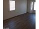 Living room area with modern floors and natural light from windows at 3505 Benson Ln, North Las Vegas, NV 89032