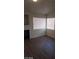 A cozy living room featuring a fireplace, wood floors, and ample natural light from large windows at 3505 Benson Ln, North Las Vegas, NV 89032