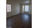 A bright, airy living room with wood floors and ample natural light from large windows at 3505 Benson Ln, North Las Vegas, NV 89032