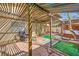 Backyard with lounge chair under a wood pergola looking towards a jacuzzi area at 4745 Desert Vista Rd, Las Vegas, NV 89121