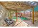 View of backyard with wood pergola, jacuzzi, and comfortable lounge chair at 4745 Desert Vista Rd, Las Vegas, NV 89121