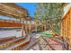Backyard deck area with jacuzzi, pergola, wooden decking, and brick pathway at 4745 Desert Vista Rd, Las Vegas, NV 89121