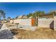 This backyard features a concrete patio, an outdoor grill, and a wooden gate for access to the property at 4745 Desert Vista Rd, Las Vegas, NV 89121