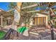 Backyard with wooden deck, pergola, unique tree, and wooden doors to home's interior at 4745 Desert Vista Rd, Las Vegas, NV 89121