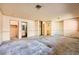 Large carpeted main bedroom showcasing multiple doorways, vintage wallpaper, and walk-in closets at 4745 Desert Vista Rd, Las Vegas, NV 89121