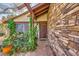 Charming front porch featuring stone accents, lush plants, and a covered entryway to the front door at 4745 Desert Vista Rd, Las Vegas, NV 89121