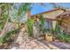Exterior of a home with brick pathway and lush vegetation plus an accent wall at 4745 Desert Vista Rd, Las Vegas, NV 89121