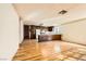 Bright kitchen area featuring wood floors and adjacent dining area with dark wood cabinets and white appliances at 4745 Desert Vista Rd, Las Vegas, NV 89121