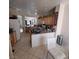 Bright kitchen featuring tile floors, a breakfast bar, and ample cabinet space with modern appliances at 4037 Gliding Gulls Ave, North Las Vegas, NV 89084