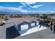 Aerial view of a blue multi-garage home with a tile roof, surrounded by desert landscaping at 3301 Rodeo Ave, Pahrump, NV 89048