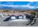 Overhead view of blue single-story home with large driveway, three-car garage, and desert surroundings at 3301 Rodeo Ave, Pahrump, NV 89048