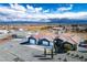 Aerial view of a blue home with a large lot, desert landscaping, and three-car garage at 3301 Rodeo Ave, Pahrump, NV 89048