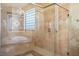 Beautifully designed bathroom with a glass-enclosed shower, soaking tub, and decorative tile accents at 3301 Rodeo Ave, Pahrump, NV 89048