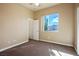 This bedroom offers neutral walls and carpet, closet space, and a bright window with neighborhood views at 3301 Rodeo Ave, Pahrump, NV 89048