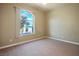 This bedroom features carpet, neutral paint, and a large picture window at 3301 Rodeo Ave, Pahrump, NV 89048