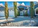 A view of the home's front exterior with landscaped garden and gated entrance at 3301 Rodeo Ave, Pahrump, NV 89048